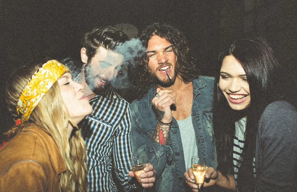 Four people smoking at night in party